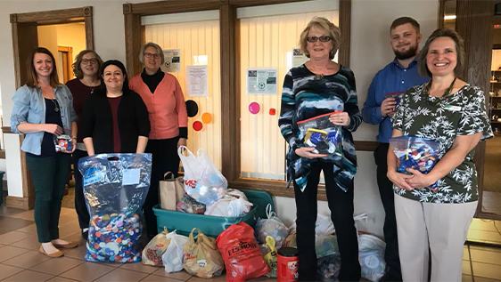 Bankers posing with donations