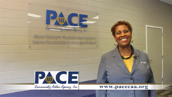 Woman posing in front of community organization sign