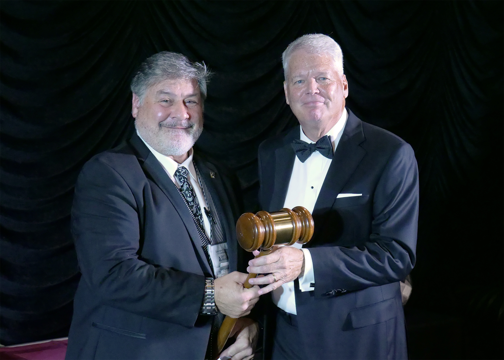 Garry Kleer passes the gavel to Jamie Shinabarger