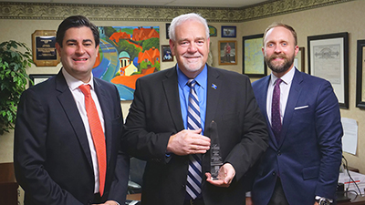 Dax Denton and Eric Augustus presenting Legislator of the Year Award to Rep. Matt Lehman